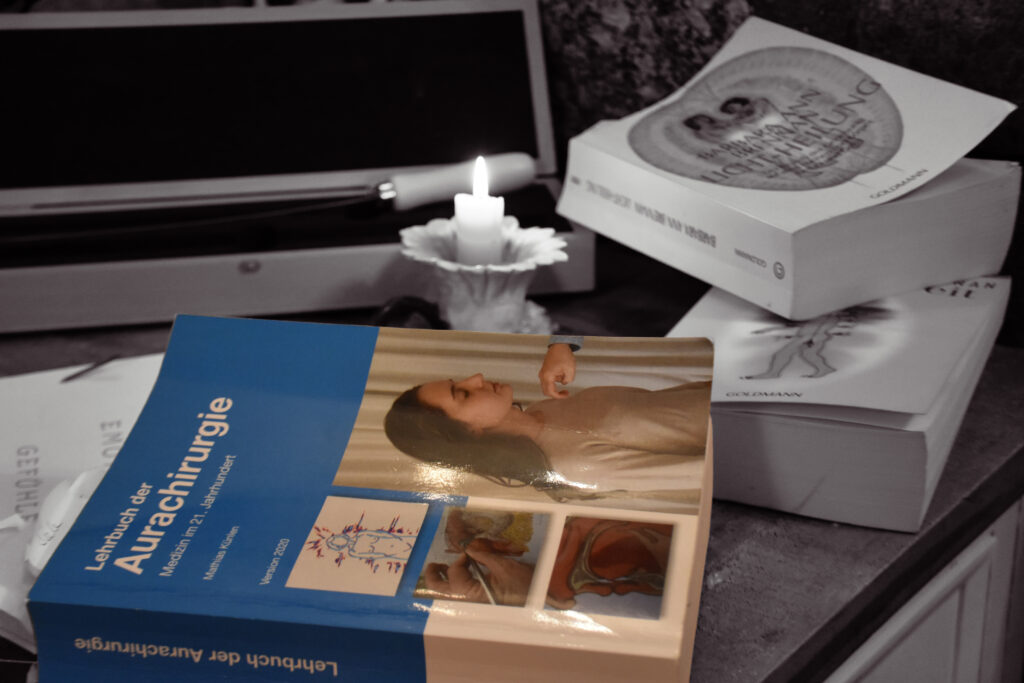 B&uuml;cher von Gabriela Anderst auf einem Schreibtisch mit einer Kerze